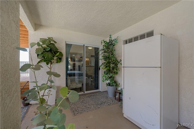 entrance to property featuring stucco siding