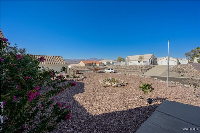 view of yard with a residential view and fence