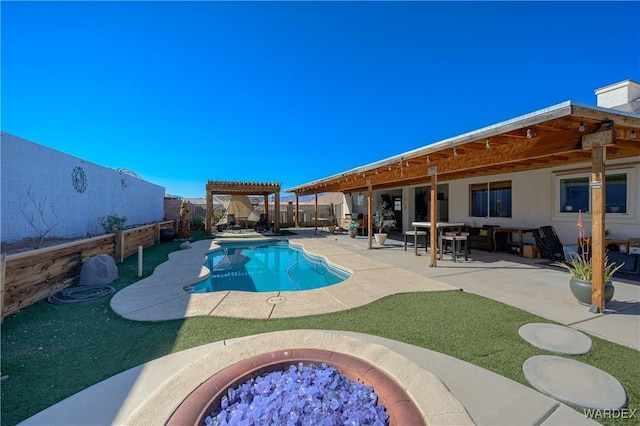 view of swimming pool featuring a fire pit, a fenced in pool, a patio, a fenced backyard, and a pergola