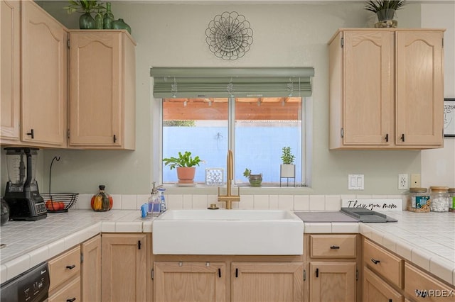 kitchen featuring tile countertops, light brown cabinetry, and a sink