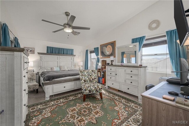 bedroom featuring a ceiling fan, lofted ceiling, and dark colored carpet