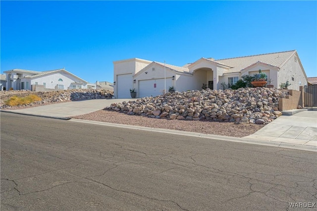 single story home featuring a tile roof, an attached garage, fence, a residential view, and driveway