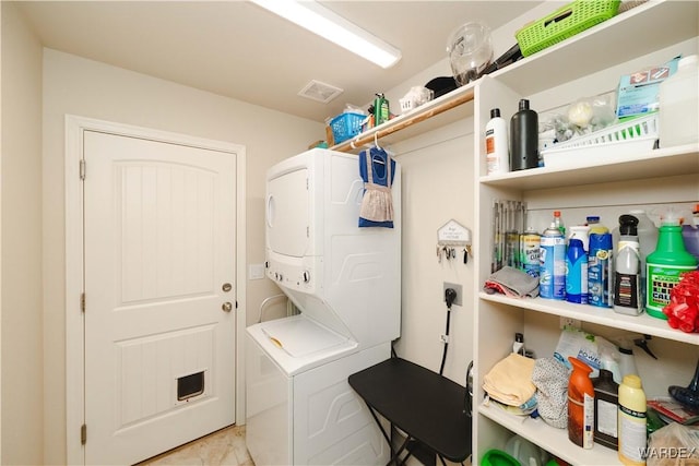 washroom with laundry area, visible vents, and stacked washer and clothes dryer