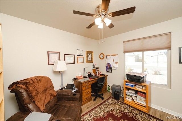 office with ceiling fan, baseboards, and wood finished floors