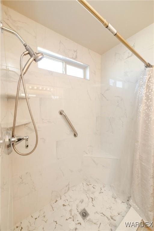 full bathroom featuring a marble finish shower