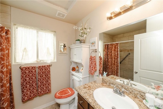 bathroom with visible vents, a tile shower, vanity, and toilet