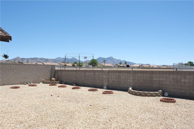 fenced backyard with a mountain view