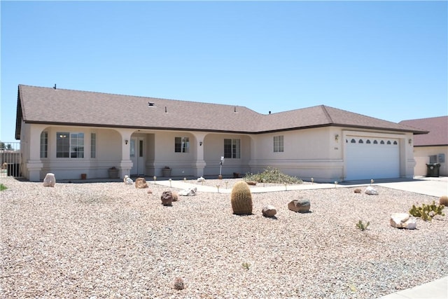 single story home with an attached garage, driveway, and stucco siding