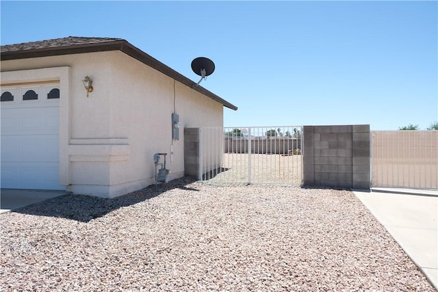 view of home's exterior with fence and an attached garage