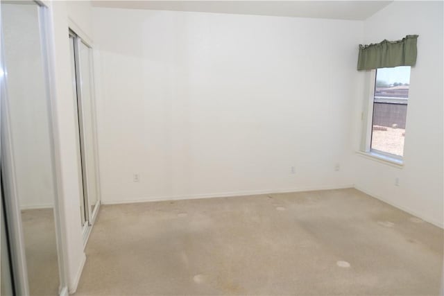 empty room with light carpet and baseboards
