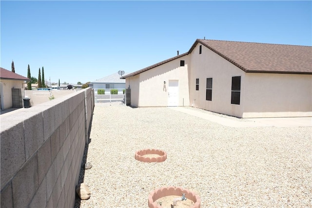 view of home's exterior featuring fence and stucco siding