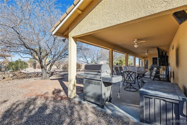 view of patio / terrace featuring grilling area, outdoor dining area, and a ceiling fan