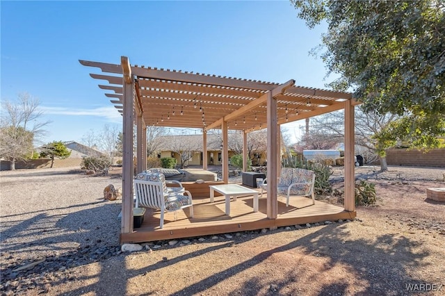 exterior space with a deck, fence, and a pergola