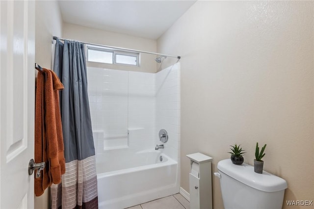 full bathroom featuring toilet, shower / bath combo with shower curtain, and tile patterned floors