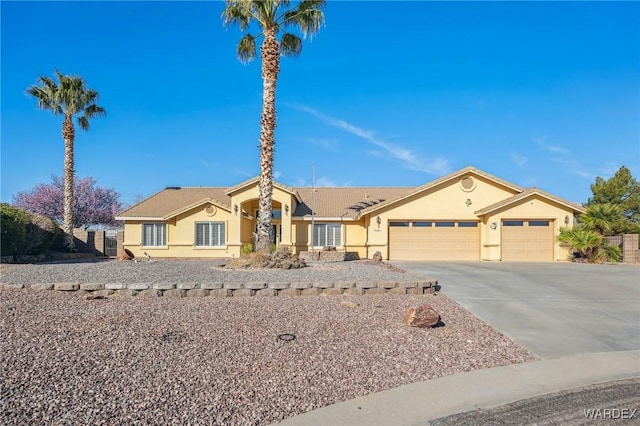 single story home with an attached garage, concrete driveway, and stucco siding