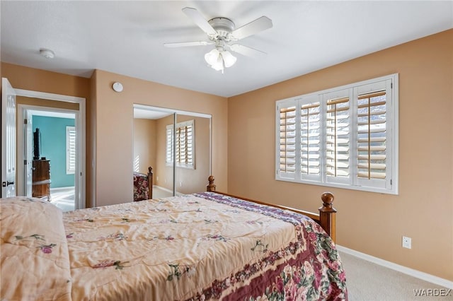 carpeted bedroom featuring a closet, a ceiling fan, and baseboards