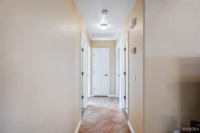 hall with baseboards and light tile patterned floors