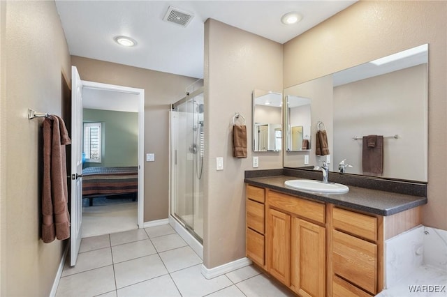 ensuite bathroom with visible vents, ensuite bathroom, a stall shower, vanity, and tile patterned flooring