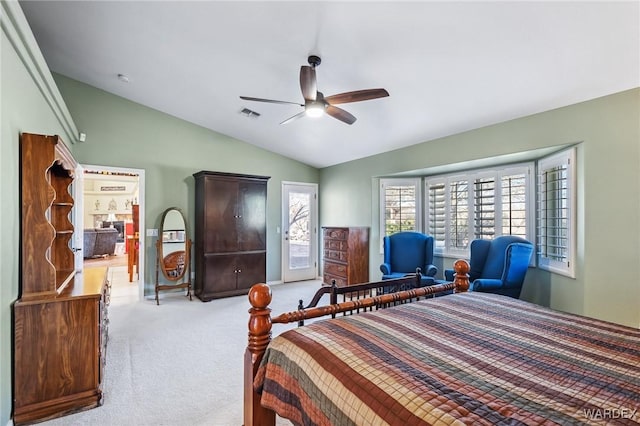 carpeted bedroom featuring lofted ceiling, visible vents, and ceiling fan