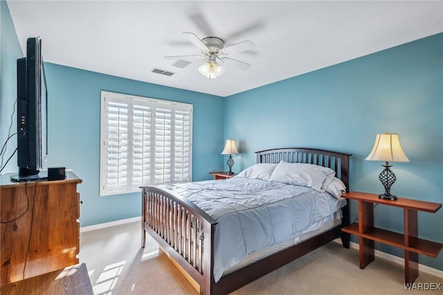 carpeted bedroom with a ceiling fan, visible vents, and baseboards