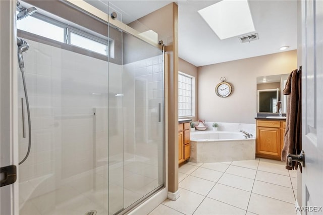 bathroom featuring tile patterned floors, a shower stall, visible vents, and vanity