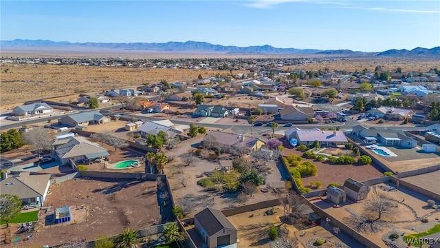 aerial view with view of desert, a residential view, and a mountain view