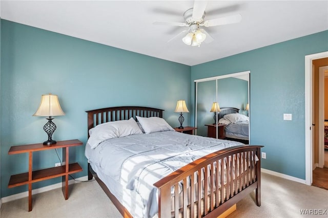 carpeted bedroom featuring a ceiling fan, a closet, and baseboards