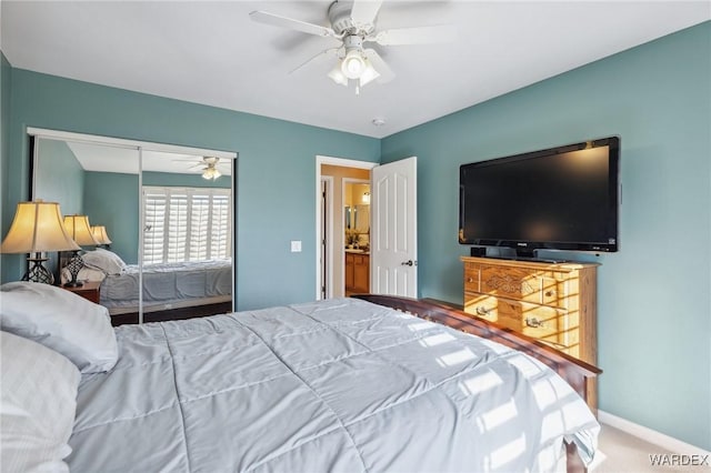 carpeted bedroom with ceiling fan, a closet, and baseboards