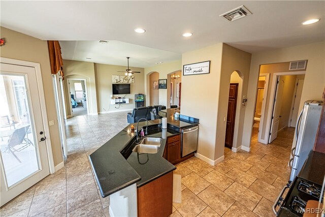 kitchen featuring stainless steel appliances, arched walkways, and visible vents