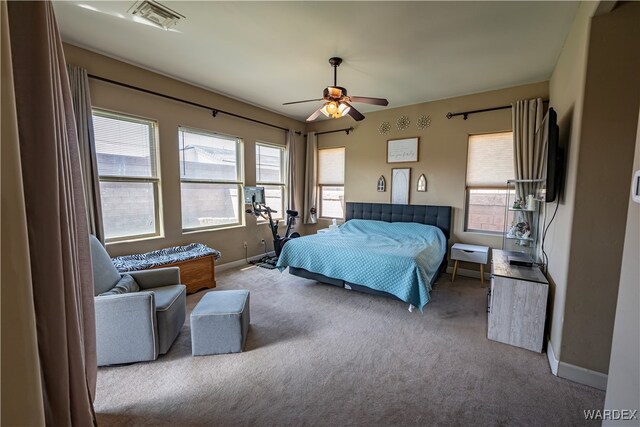 carpeted bedroom featuring ceiling fan, visible vents, and baseboards