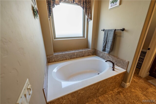 full bath with tile patterned flooring and a bath