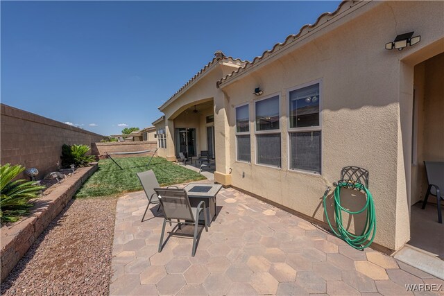 view of patio / terrace with a fire pit and a fenced backyard