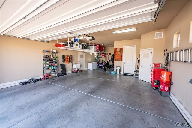 garage with a sink, visible vents, and a garage door opener