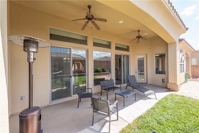 view of patio with fence and a ceiling fan