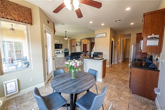 dining area with visible vents, arched walkways, baseboards, and recessed lighting