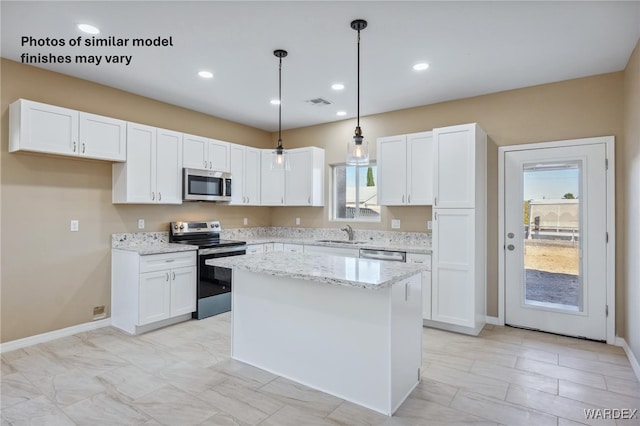 kitchen featuring white cabinetry, a healthy amount of sunlight, appliances with stainless steel finishes, and a sink