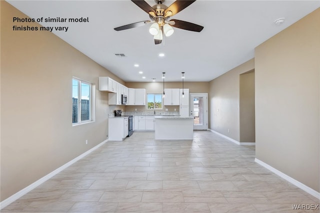 kitchen featuring stainless steel appliances, white cabinets, ceiling fan, baseboards, and visible vents