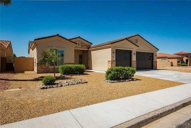 single story home with stone siding, an attached garage, driveway, and stucco siding