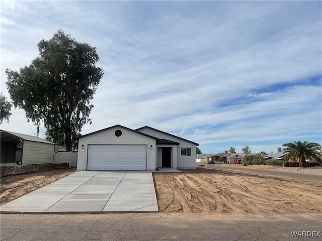 view of front of house with an attached garage, concrete driveway, and stucco siding