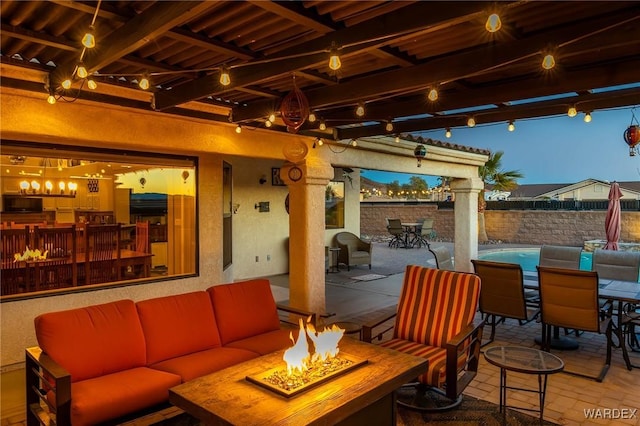 view of patio / terrace with outdoor dining area, an outdoor living space with a fire pit, and fence