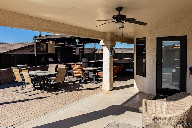 view of patio / terrace featuring ceiling fan, outdoor dining area, and fence