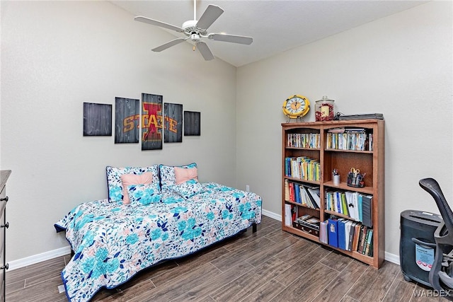 bedroom featuring baseboards, vaulted ceiling, and wood finish floors