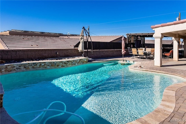 view of swimming pool featuring a fenced in pool, a fenced backyard, and a patio