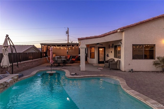 view of pool with ceiling fan, a patio, a fenced backyard, and a fenced in pool