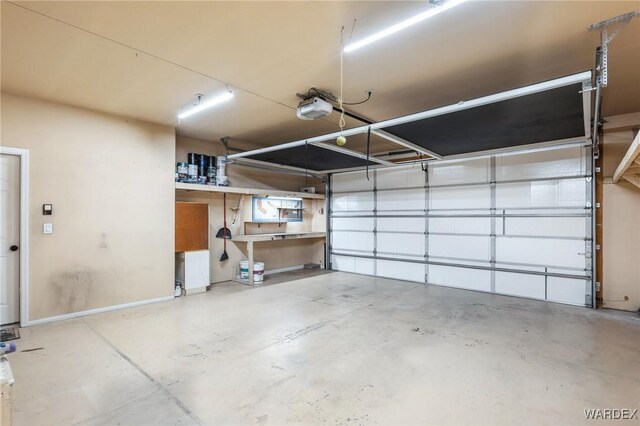 garage featuring baseboards and a garage door opener