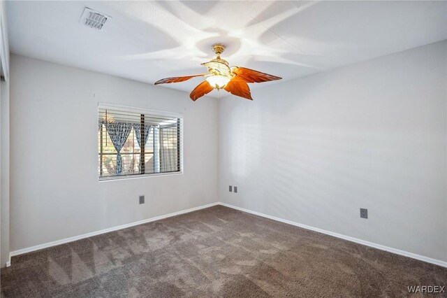 spare room with ceiling fan, carpet, visible vents, and baseboards