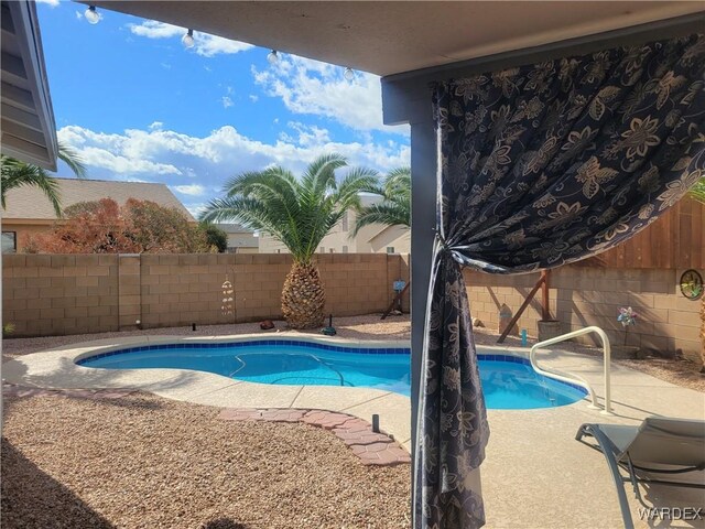 view of swimming pool with a patio area, a fenced backyard, and a fenced in pool