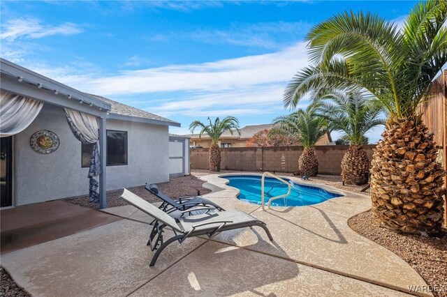 view of swimming pool with a fenced in pool, a fenced backyard, and a patio