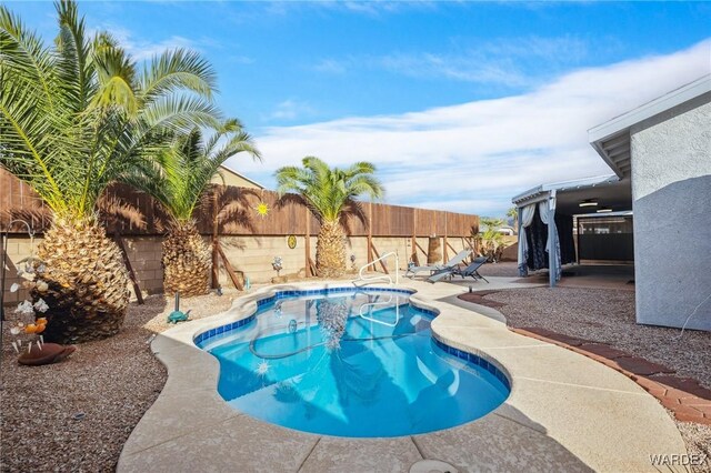 view of swimming pool with a patio area, a fenced backyard, and a fenced in pool