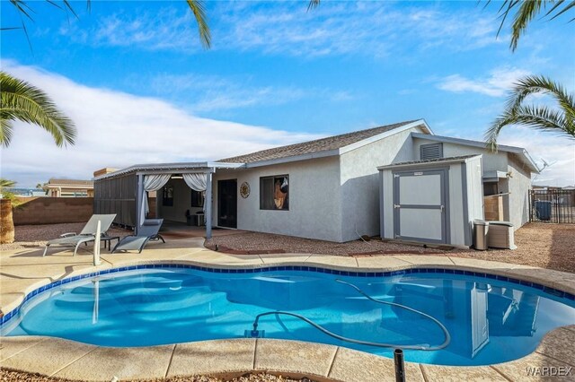 view of pool featuring a fenced in pool, an outbuilding, fence, and a patio